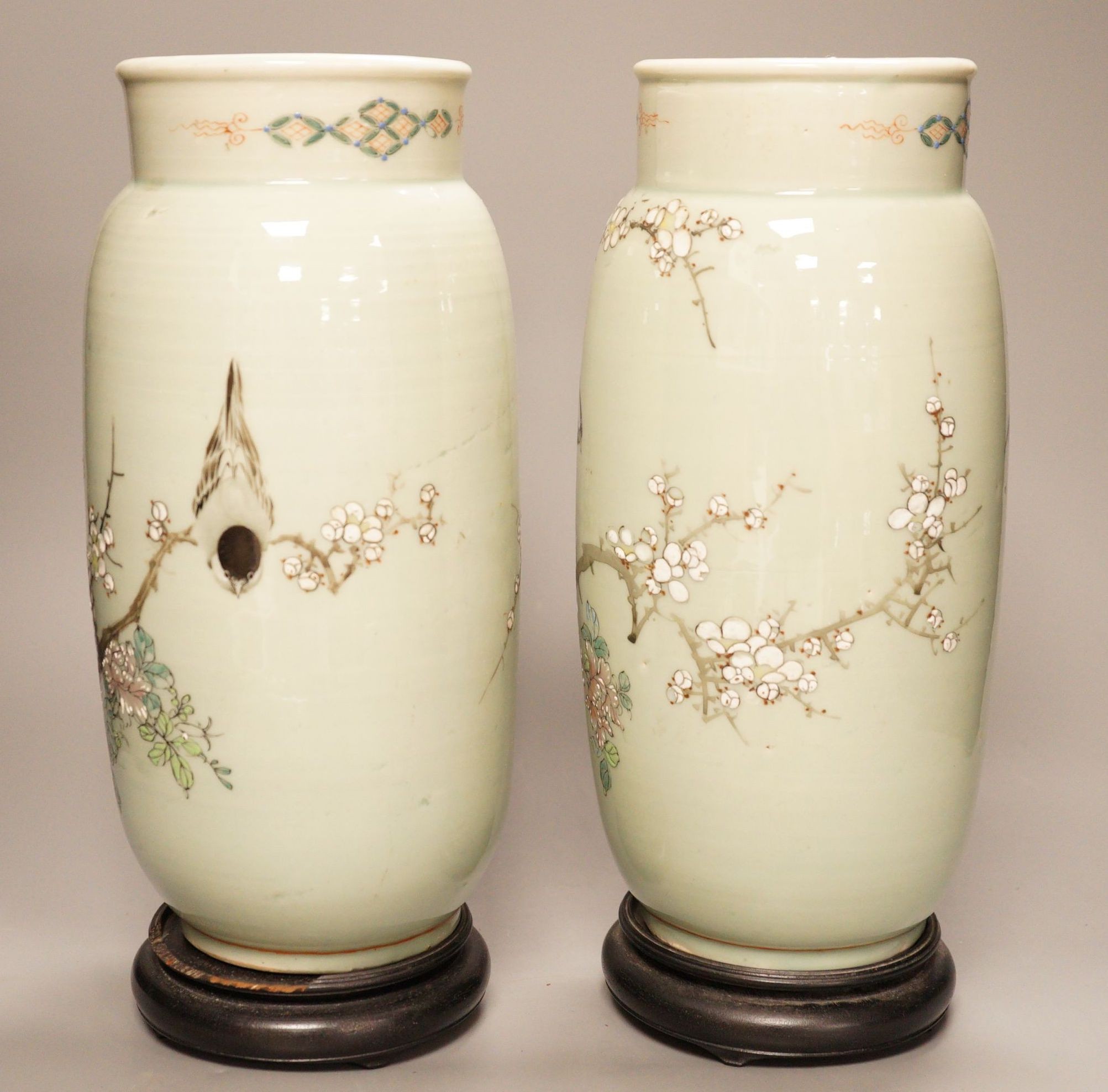 A pair of 19th century Japanese celadon glazed vases (drilled) with hardwood stands, total height 31cm